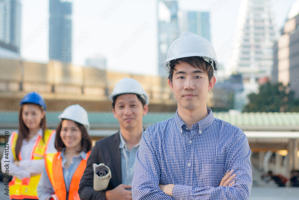 Portrait happy team,group of asian businessman and businesswoman Team professional engineers and architect working on site,with blueprints building site,on workplace with three partners background Portrait happy team,group of asian businessman and businesswoman Team professional engineers and architect working on site,with blueprints building site,on workplace with three partners background