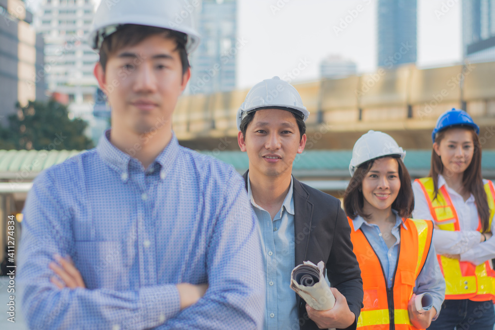 Portrait happy team,group of asian businessman and businesswoman Team professional engineers and architect working on site,with blueprints building site,on workplace with three partners background Portrait happy team,group of asian businessman and businesswoman Team professional engineers and architect working on site,with blueprints building site,on workplace with three partners background