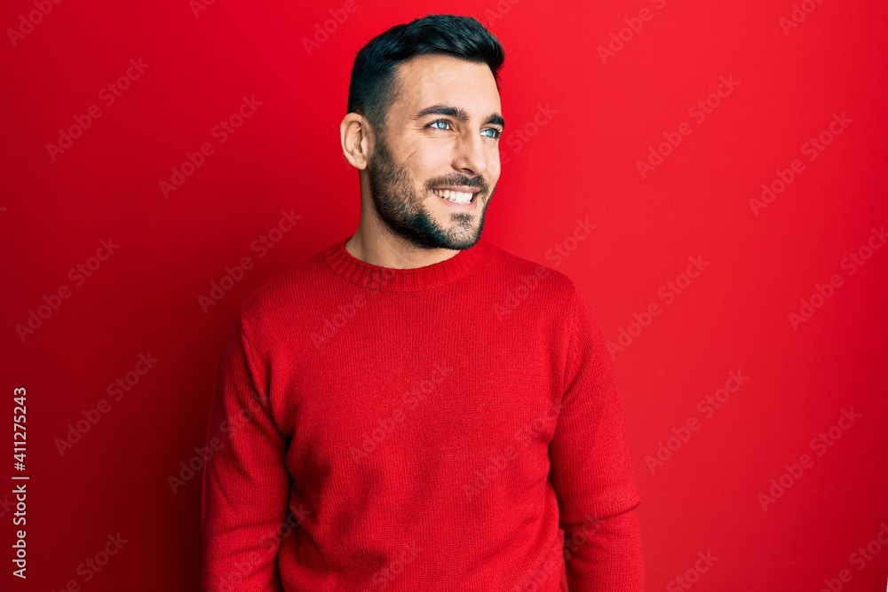 Fototapeta premium Young hispanic man wearing casual clothes looking to side, relax profile pose with natural face and confident smile.