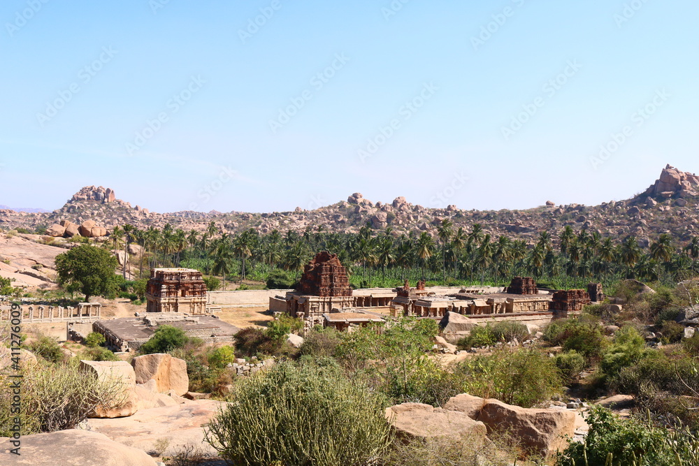 Landscape view of ancient hindu temple ruins with blue sky background, Hampi, India 