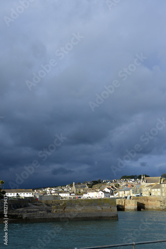 Dark clouds behind Sunny Porthleven Cornwall  © Peter