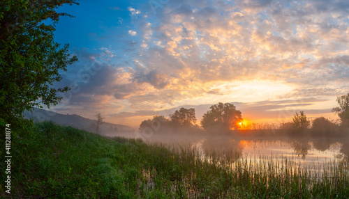 Summer landscape with river and foggy sunrise © firewings