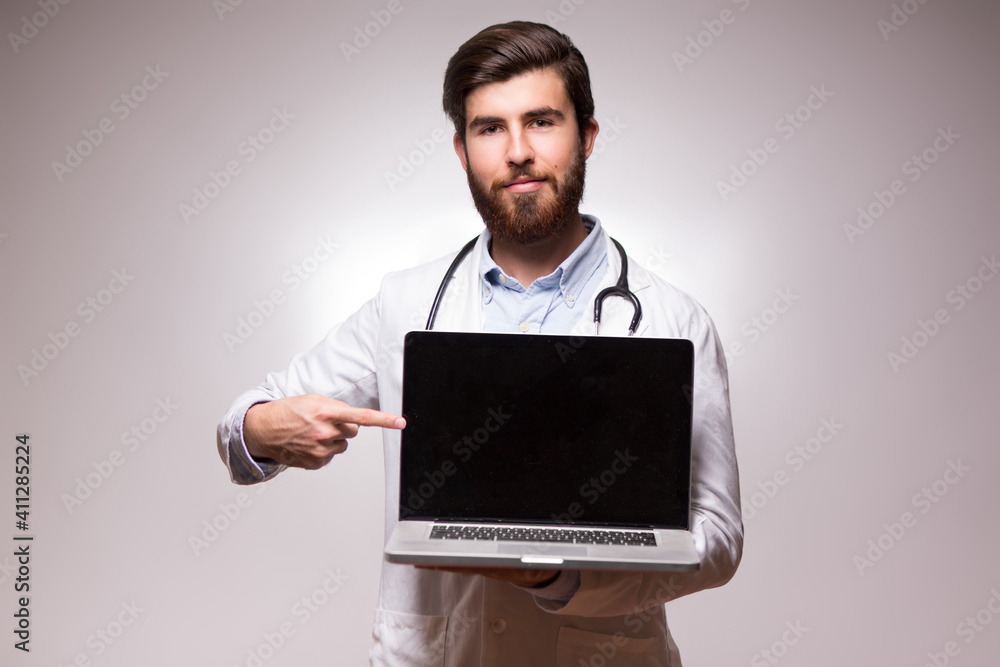Attractive doctor holding an open laptop Attractive doctor holding an open laptop