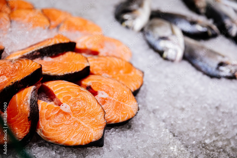 Thin salmon steaks on ice. Fish counter