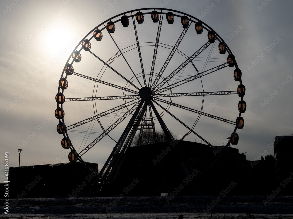 Silhouette of a ferris wheel. Late, cold afternoon.