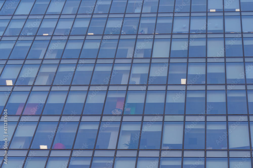 Moscow offices building exterior in winter sunny day. Blue sky had been reflected in the glass of windows. Futuristic business concept.