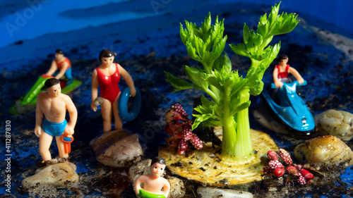 Fototapeta Naklejka Na Ścianę i Meble -  Izmir, Turkey, 02-06-2021, Celery island and miniature family and people swimming around it.