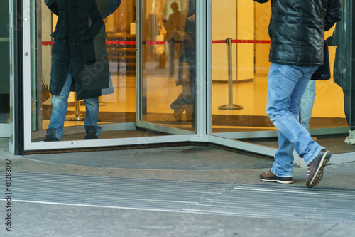 Photography of revolving office door entrance of modern Moscow International Business Center (MIBC). Business people coming. Business concepts and lifestyles. Low angle view