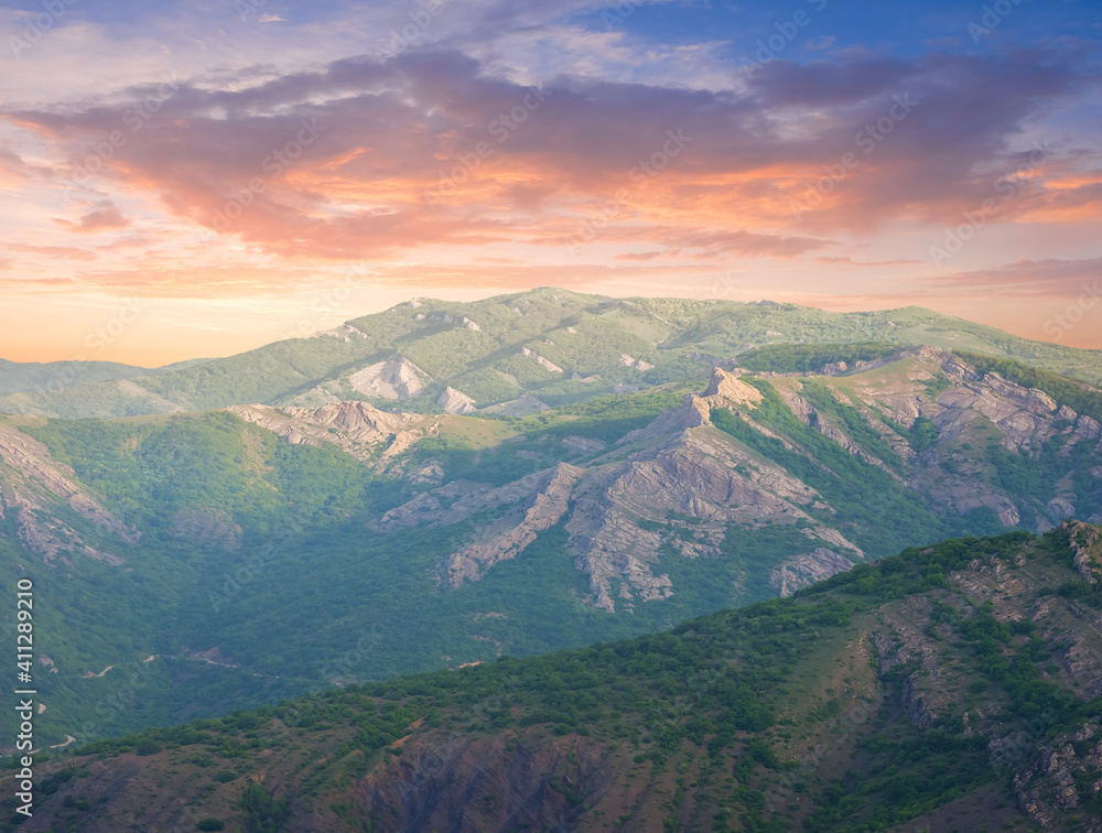 green hills under dramatic evening sky, mountain sunset backgroujd