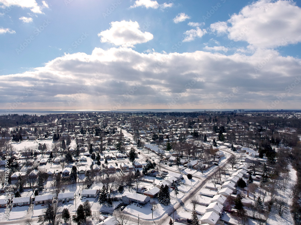 Snow view from the top with urban city, aerial photography over the suburb. Winter scenery of the American city from the bird eye.