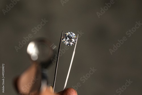 Photography Large polished round cut diamond in hand close up front view