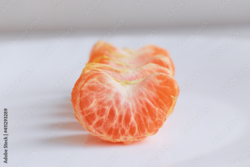 macro photo mandarin slices in a white plate close up several pieces of lie on the table background out of focus macro photo mandarin slices in a white plate close up several pieces of lie on the table background out of focus