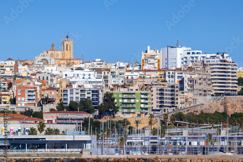 Spain; Jan 2021: Downtown views of the city of Tarragona, Cathedral church at the background, colorful apartment buildings, sailing club by the port. Tarragona by Mediterranean sea, Catalonia, Spain