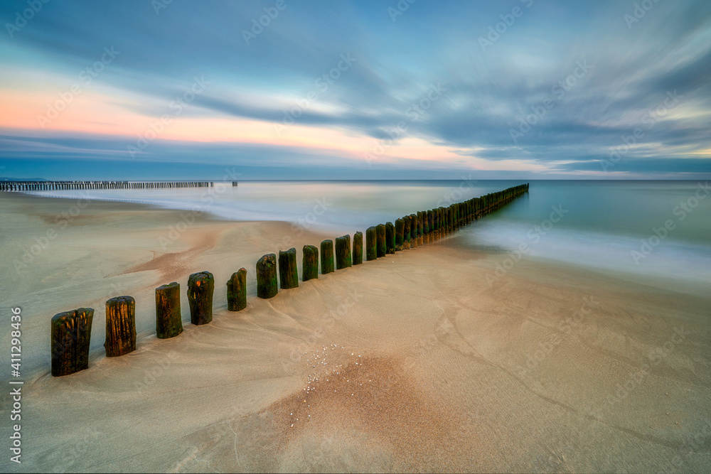 Beautiful sandy beach with a wooden breakwater. Polwysep Hel, village of Chałupy, Poland	