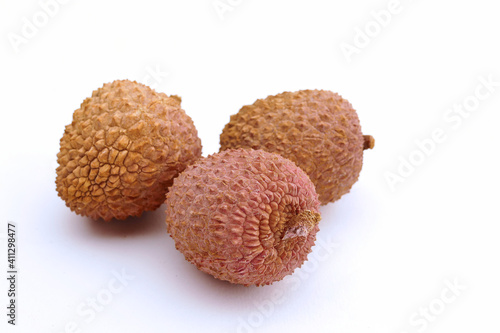 lychee fruits inside a black bowl grouped on white background, isolated, close up photo