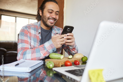 Young mature man taking cooking classes online