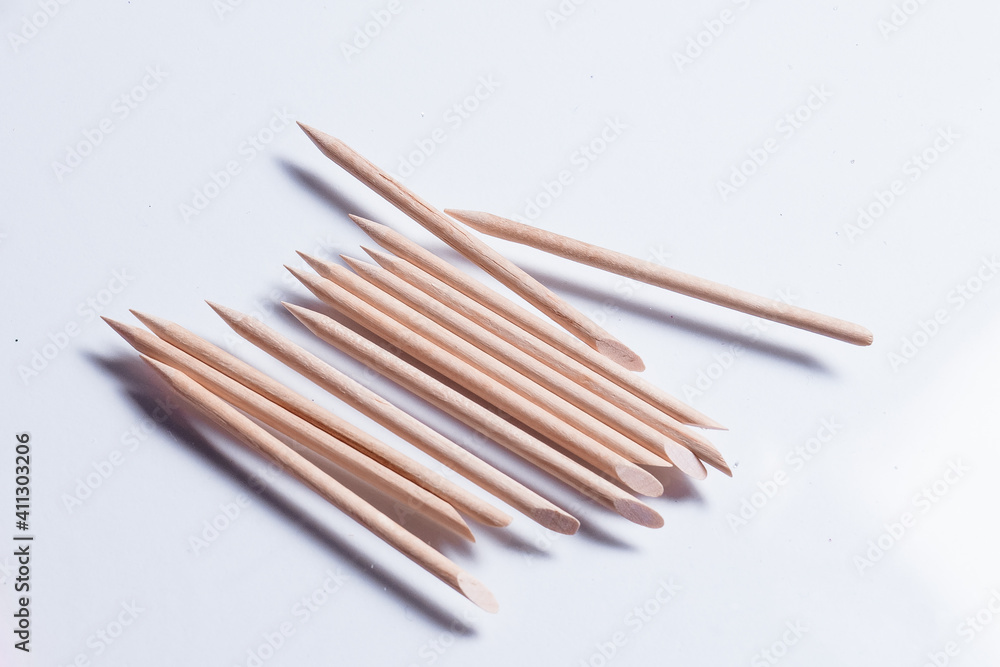 Set of cosmetic tools for manicure and pedicure on a white background. Manicure sticks top view. Set of cosmetic tools for manicure and pedicure on a white background. Manicure sticks top view.