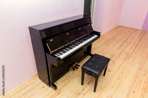 A brand new piano in the classroom. Piano training class. Music class interior element. The system of preschool education of children