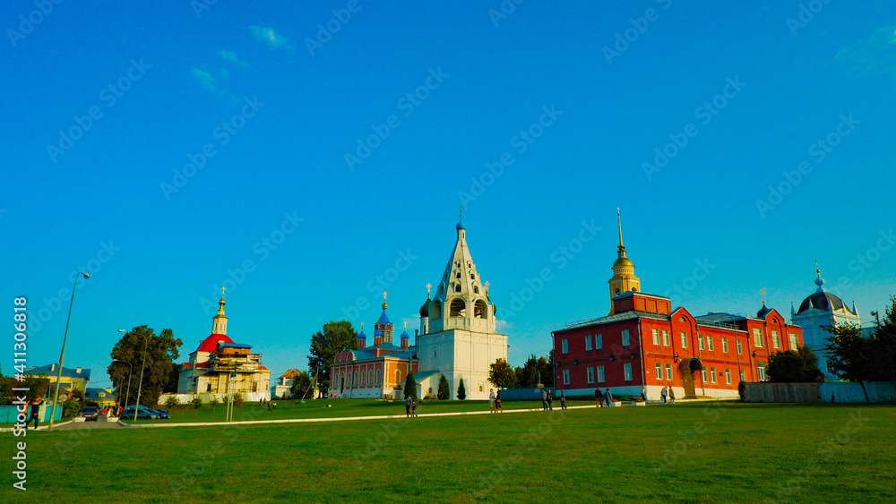 orthodox church in summer on the background of blue sky and green grass