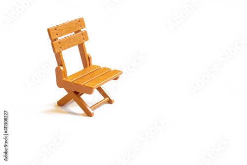 brown folding chair stands on a white background