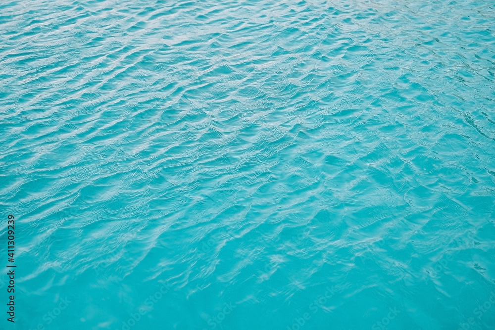 beautiful bright blue water, texture of the water surface of blue color. beautiful bright blue water, texture of the water surface of blue color.