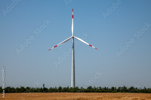 wind turbines on cloudy blue sky background