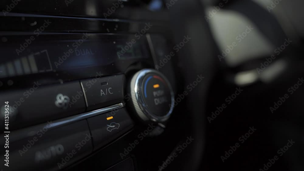 Hand push the car's air conditioner button, 4K, soft focus Hand push the car's air conditioner button, 4K, soft focus