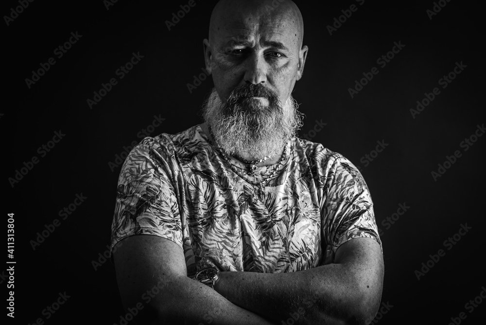 Fototapeta premium close up, portrait of emotional, thoughtful, handsome positive young bearded businessman man. Low key isolated on dark background. Body language 