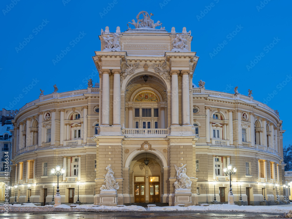 central view to the building of opera theatre in Odessa in Ukraine in winter morning with wet asphalt and street lights