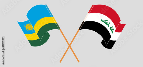 Crossed and waving flags of Rwanda and Iraq