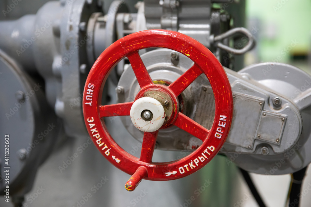 Metal red faucet valve for closing pipes with water, steam, liquid, gas. Control of the movement of liquids and gases through pipes. Metal red faucet valve for closing pipes with water, steam, liquid, gas. Control of the movement of liquids and gases through pipes.