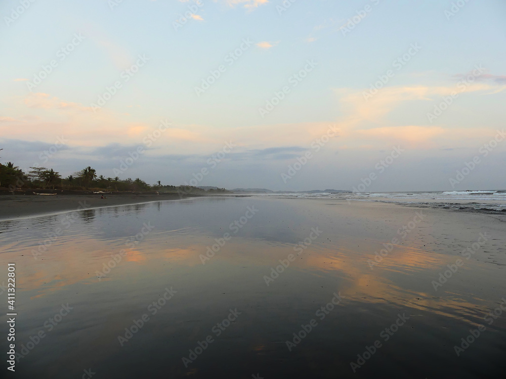 Beautiful sunset at the beach, with large water mirror reflecting the sky. In the Pacific coast of Costa Rica. Beautiful sunset at the beach, with large water mirror reflecting the sky. In the Pacific coast of Costa Rica.