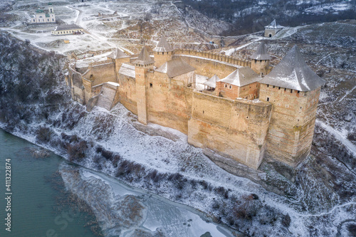 aerial view to old castle on the snowed hill close to river in Ukraine