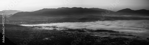 Black and white view of Terni covered by the fog in a winter sunrise  Umbria  Italy