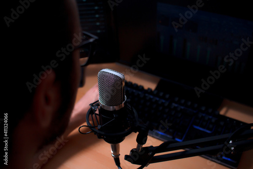 Ταπετσαρία Local radio announcer in his studio with microphone on the main stage