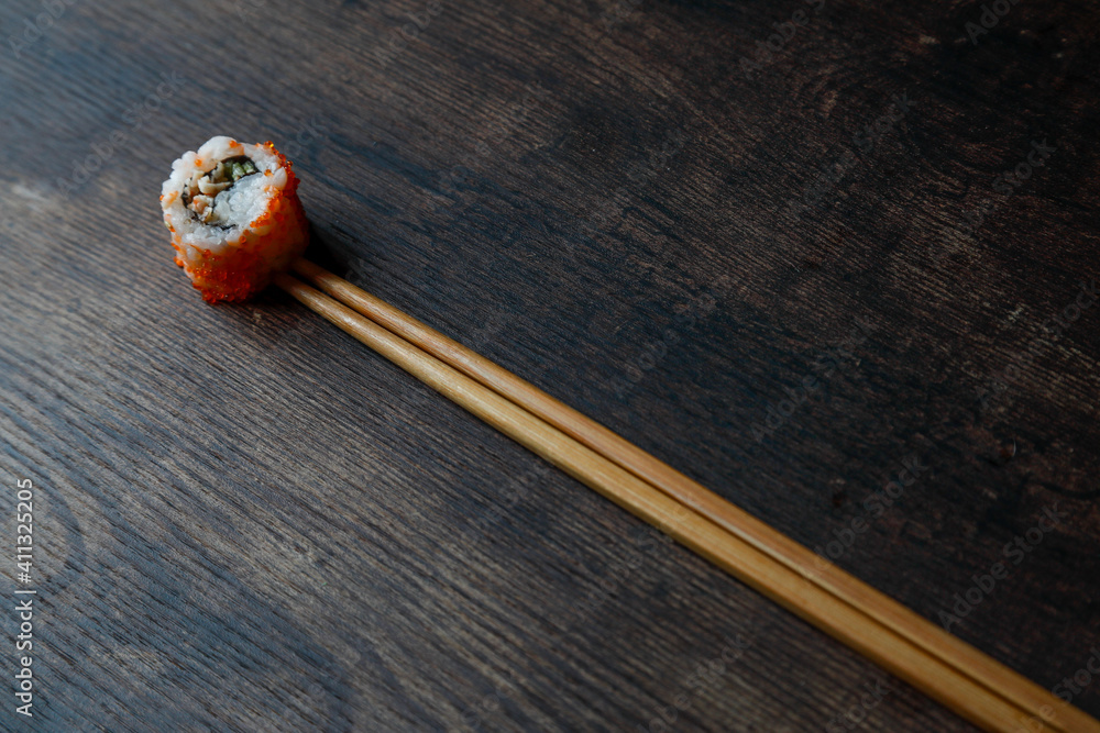 maki on gray plate and wooden table maki on gray plate and wooden table