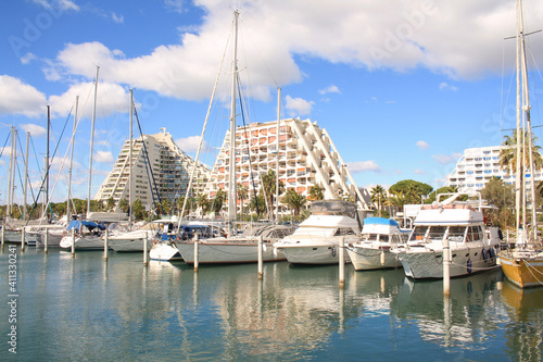 Pyramids buildings and pleasure boats in the seaside resort and marina of la Grande Motte in Herault department, France