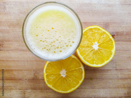Fresh oranges and glass of freshly squeezed orange juice.
