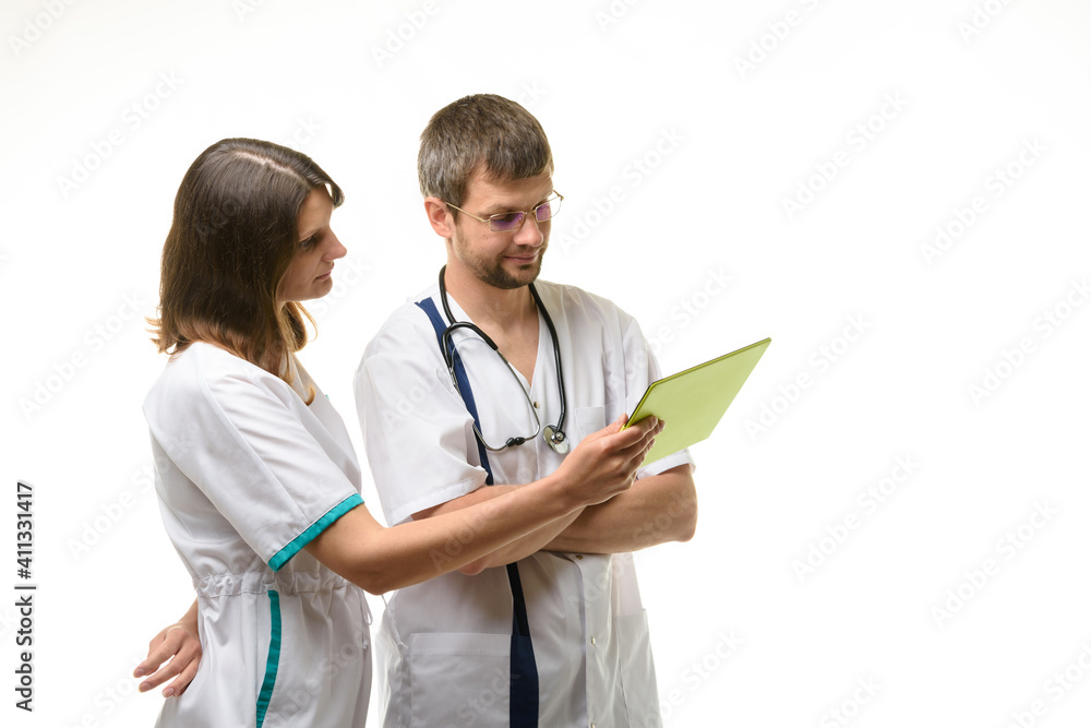 Two doctors discussing test results isolated on white background Two doctors discussing test results isolated on white background