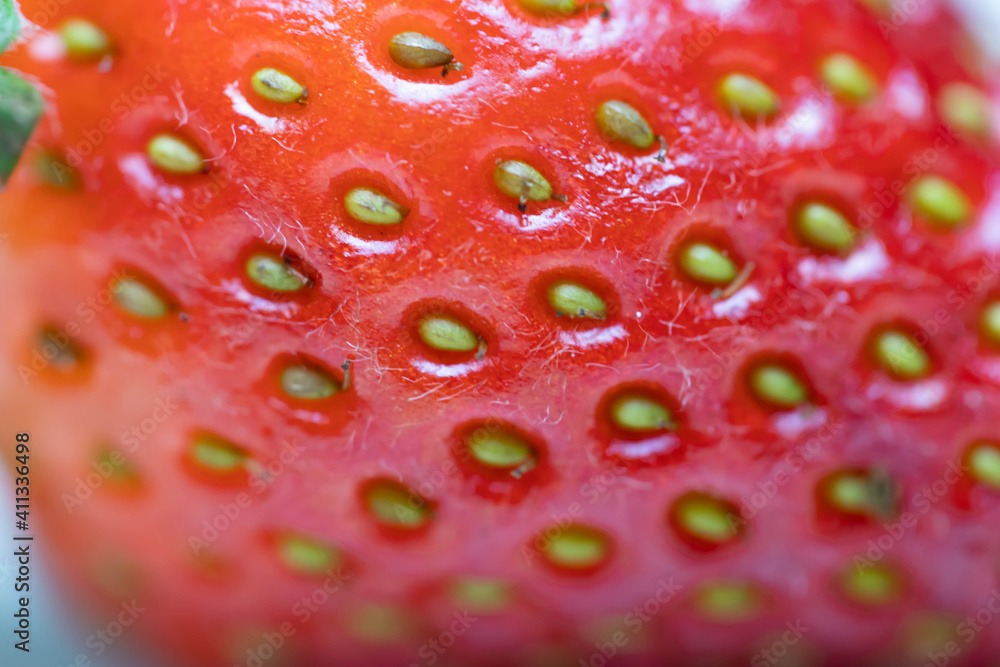 Juicy berry strawberry close-up. Macro shot of a fruit. Red-yellow photo. Juicy berry strawberry close-up. Macro shot of a fruit. Red-yellow photo.