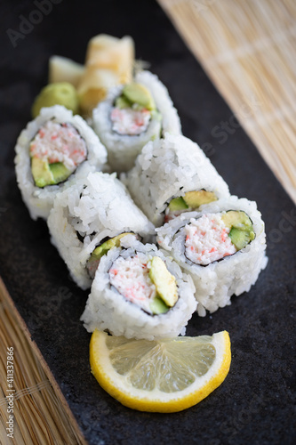 Fotografija Close-up of Japanese California Roll on a black plate