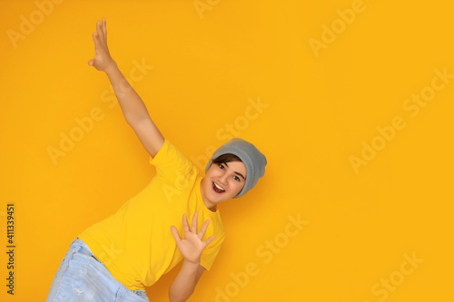 Portrait of a handsome teenager 12-13 years old on a yellow background. © Юлия Призова