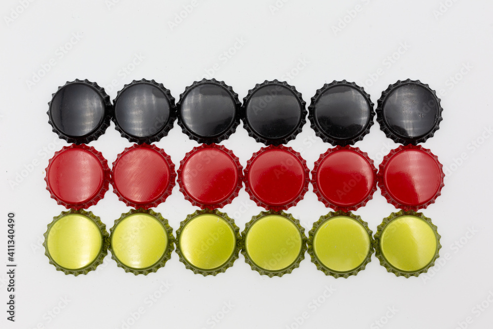 German flag made of crown corks of beer bottles in black, red and gold, symbolic for the German pleasure for beer. German flag made of crown corks of beer bottles in black, red and gold, symbolic for the German pleasure for beer.