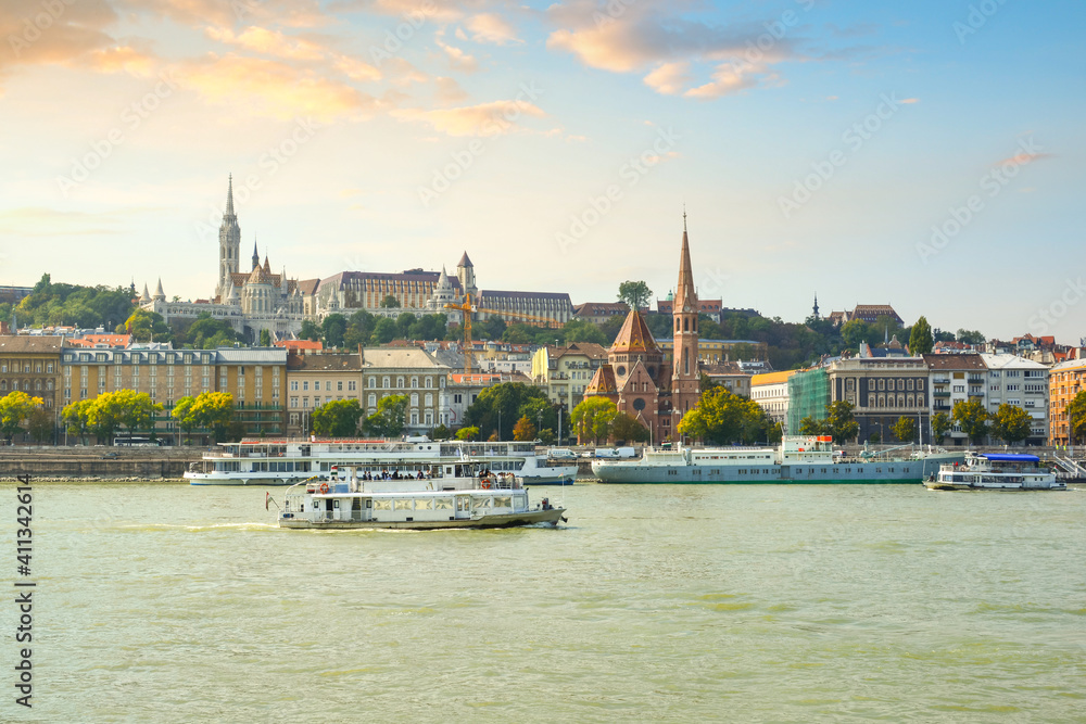 The Szilágyi Dezso Square Reformed Church on the banks of the Danube River in Budapest Hungary with the Castle District, St Matthias Church above