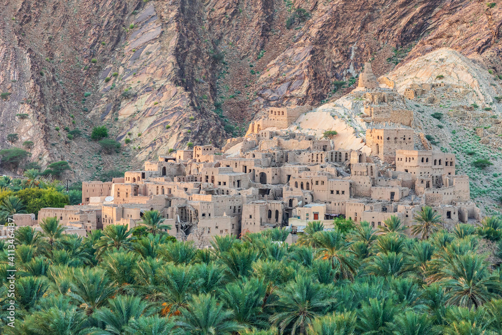 Palm trees and a traditional mountain village in Nizwa,Oman.