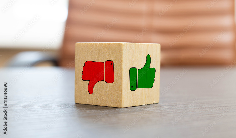 mock up miniature wooden blocks of thumbs up and thumbs down concept of like and dislike. mock up miniature wooden blocks of thumbs up and thumbs down concept of like and dislike.