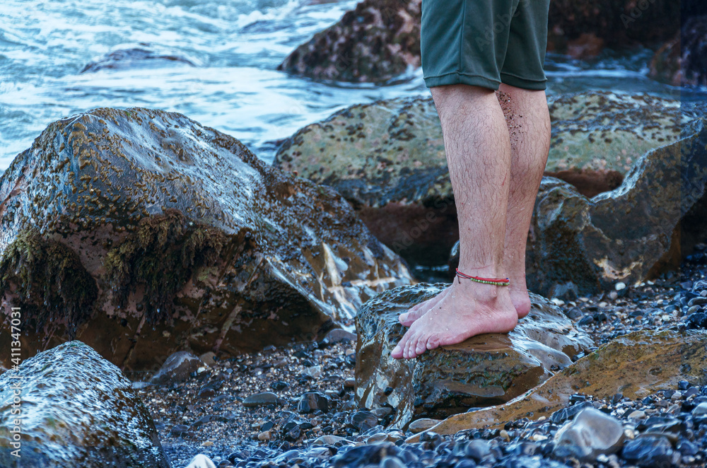 Man on rock at beach shore