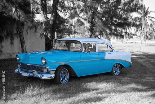 colorkey of baby blue and white classic car under old trees in havana cuba © Michael Barkmann