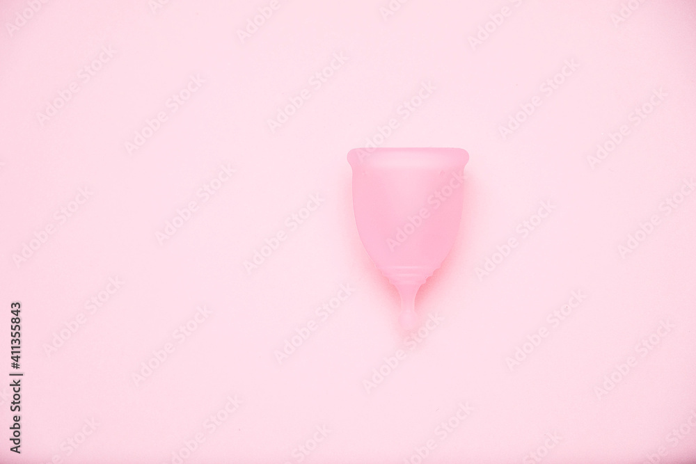 Menstrual cup on pink background. Alternative feminine hygiene product during the period. Women health concept