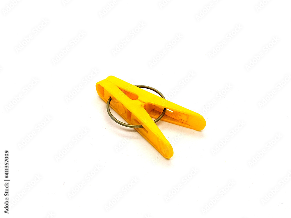 yellow clothespin. one plastic yellow clothespin on a white background side view yellow clothespin. one plastic yellow clothespin on a white background side view